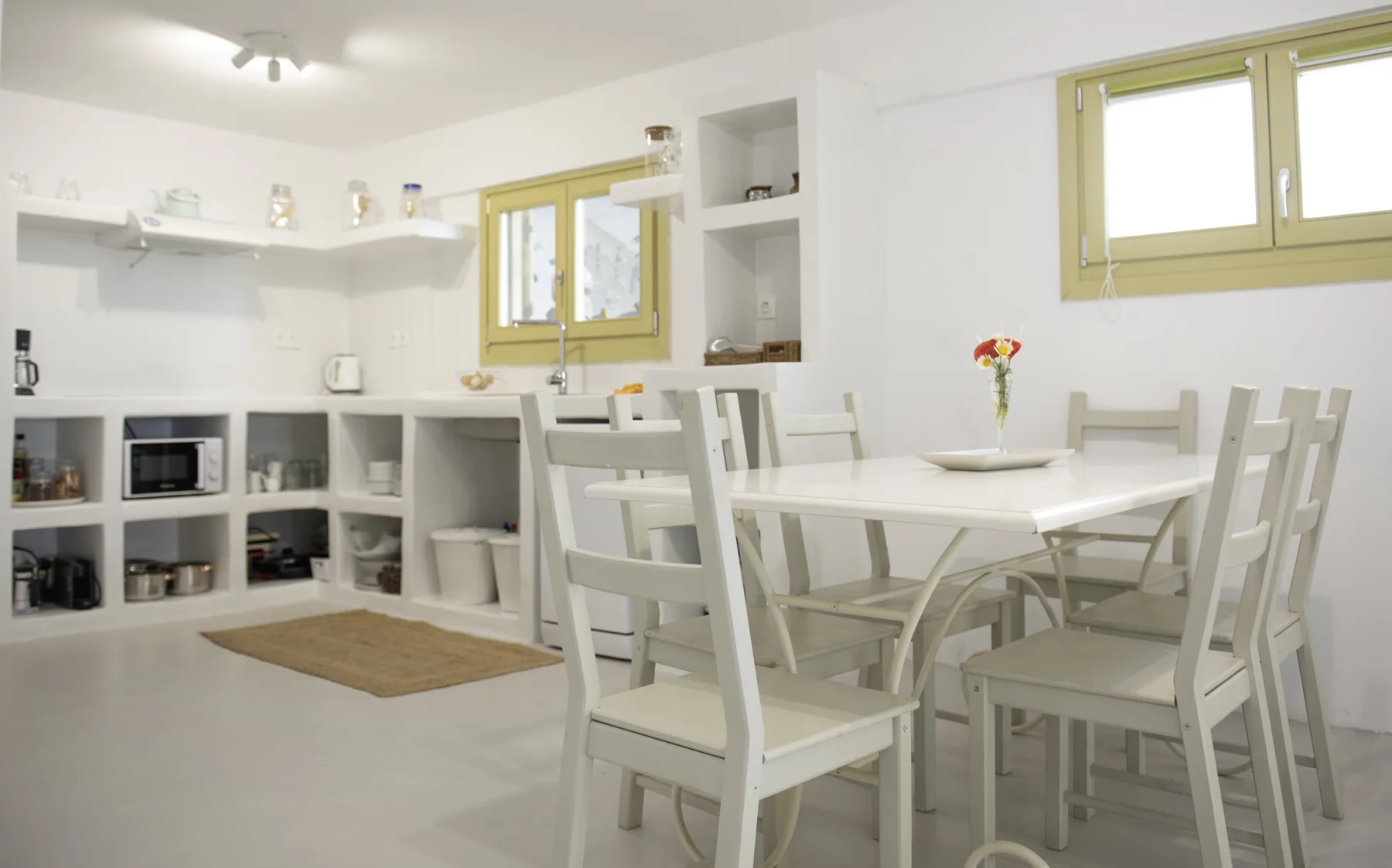 The kitchen with built-in niches and the dining table, The Maisonette